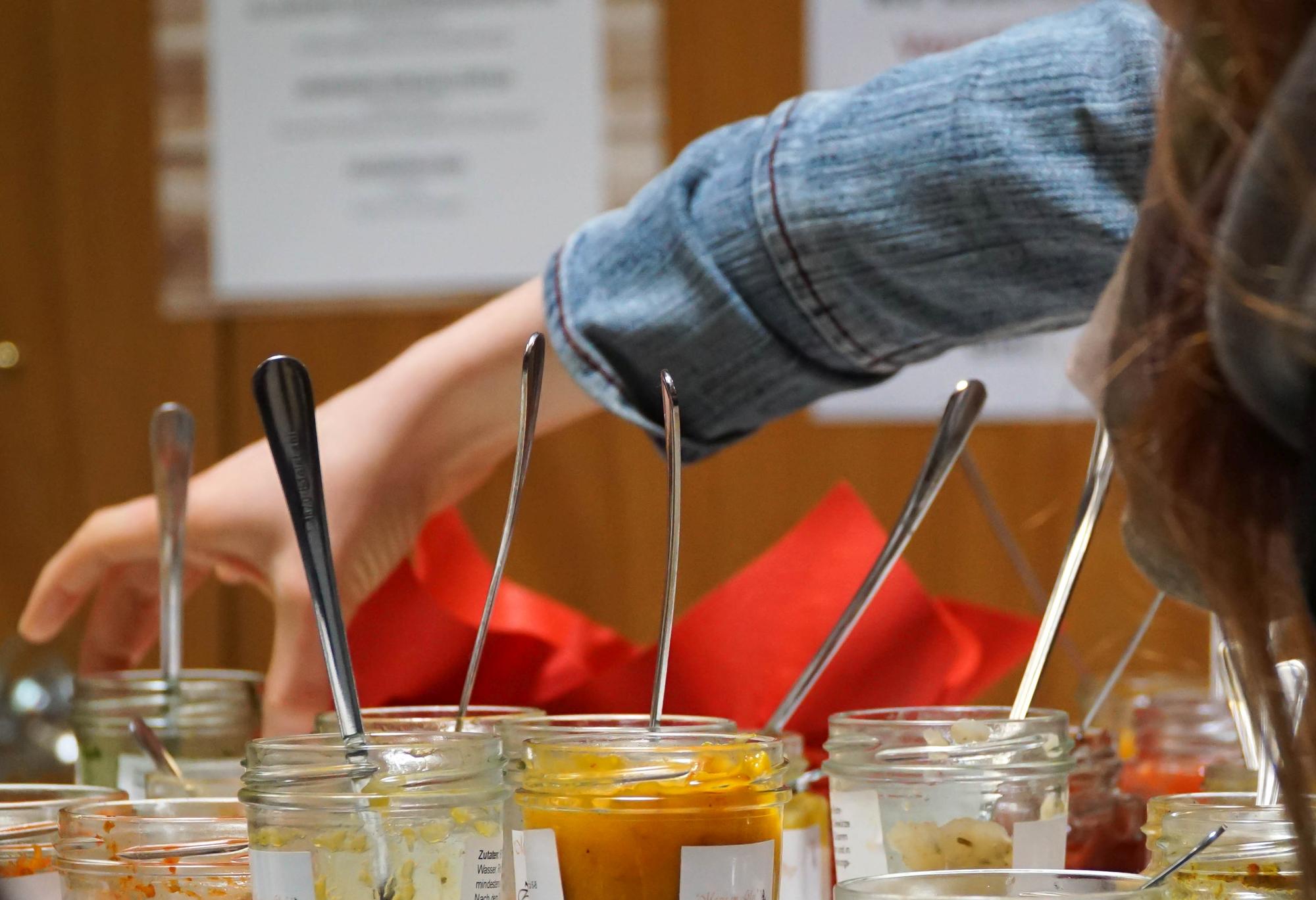 Students tasting from small spoons